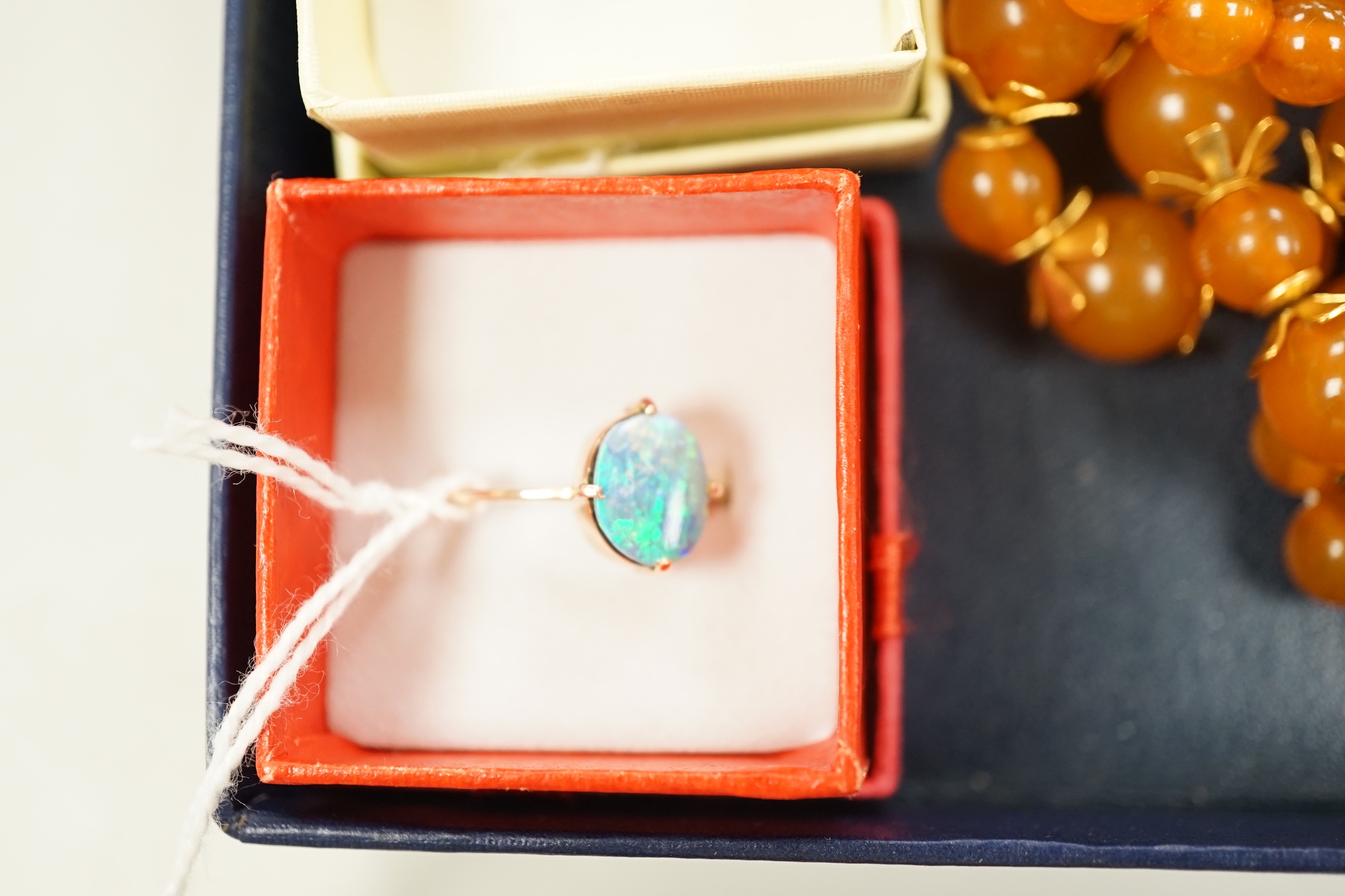 A 9ct and opal doublet ring, two other 9ct and gem set rings, an Edwardian yellow metal and swivelling carnelian ring and six assorted necklaces.